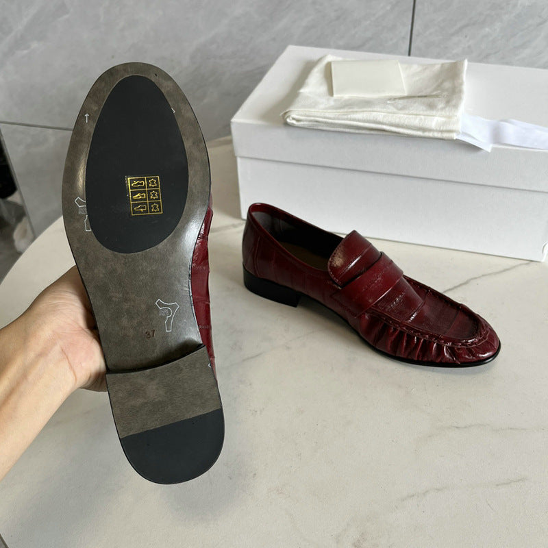 Eel skin loafers for women by Rossie Viren, showcasing sleek, textured footwear with pointed toes and slip-on design.