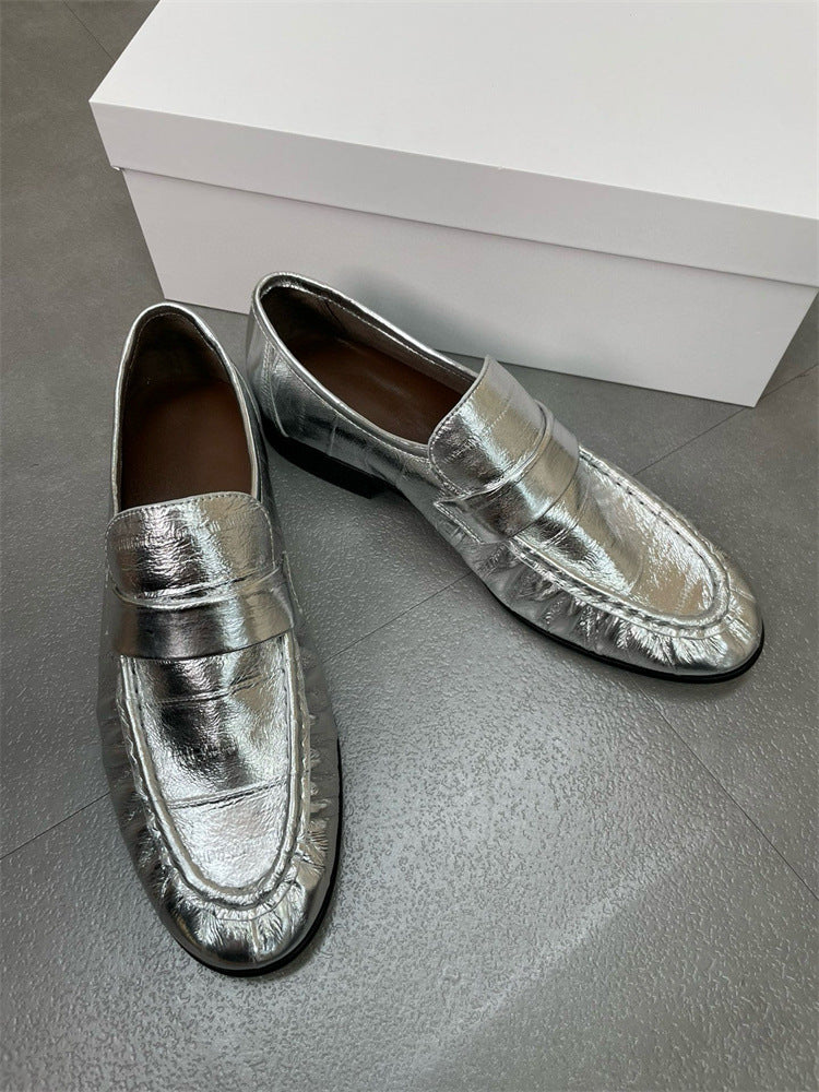 Eel skin women's loafers by Rossie Viren featuring sleek black leather shoes with slip-on design and stylish stitching.