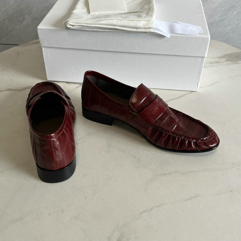 Eel skin loafers for women by Rossie Viren, featuring sleek design and textured eel skin material, perfect for stylish footwear.