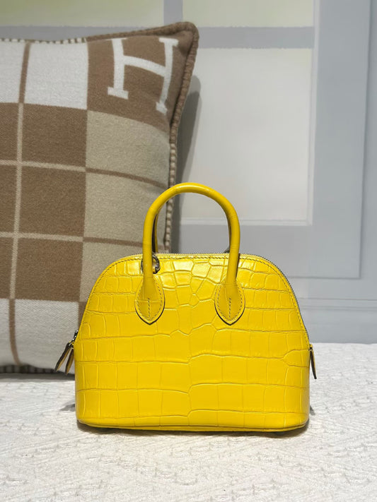 alt
Borsa mini bowling con manico superiore in vera pelle di coccodrillo gialla
