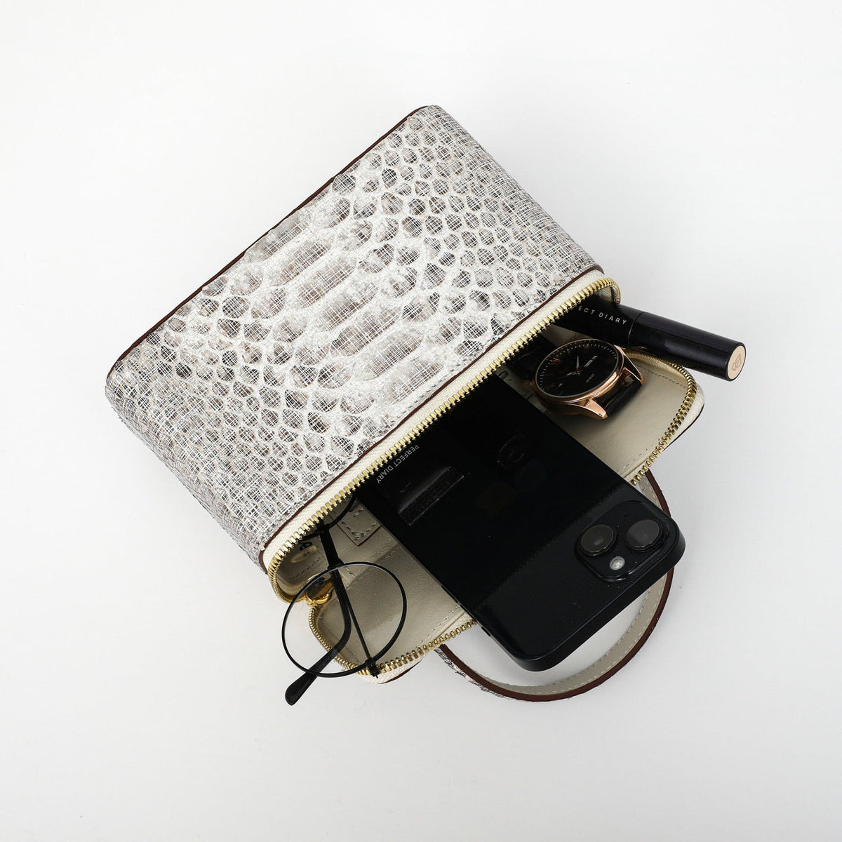 Women's Python leather top handle cosmetic crossbody bag by Rossie Viren showing the stylish handbag with top handle and compact design.